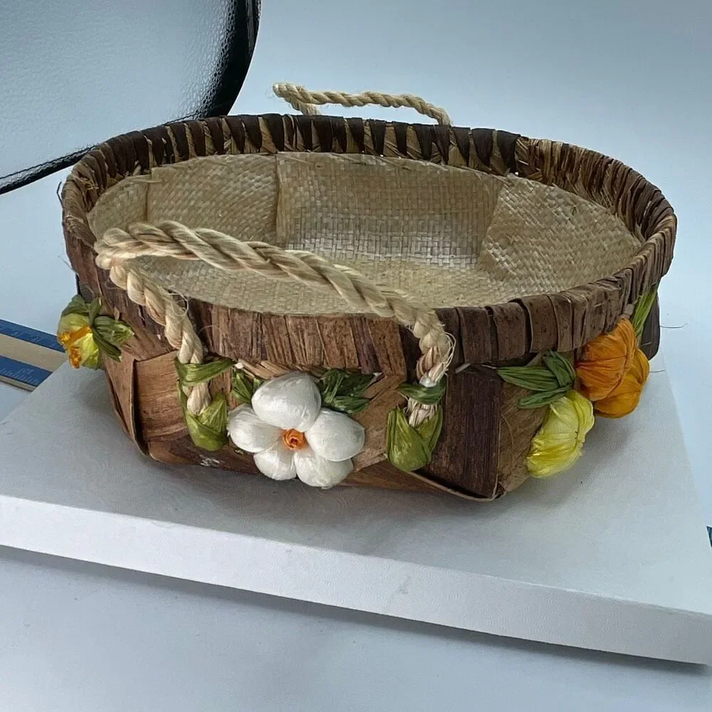 Vintage woven raffia basket with flowers and handles. Lined.